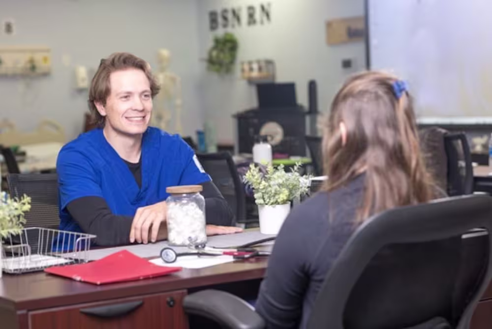 Nurse talking to doctor at office desk