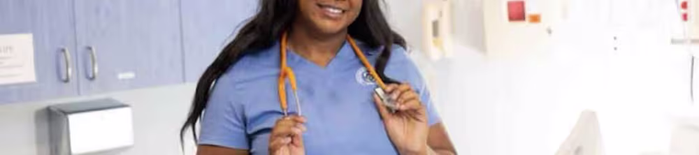 Nursing student standing in sim lab