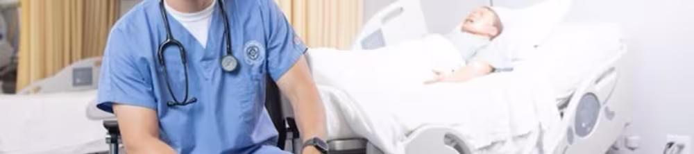 NDMU nursing student sitting in a sim lab