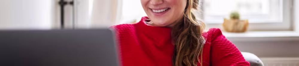 woman sitting at desk typing on a computer