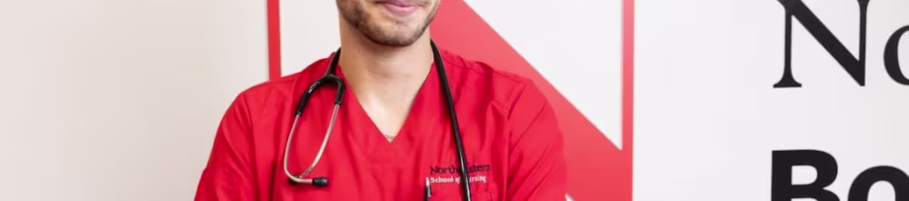 Nursing student posing by a wall