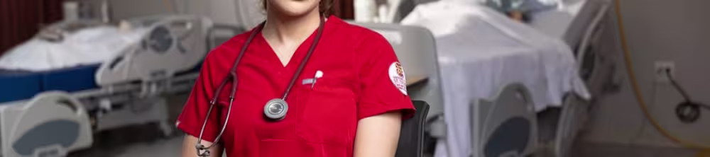 Nursing student sitting down and posing