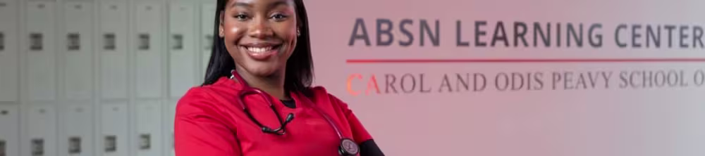 Nursing student posing in front of a wall