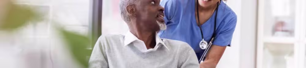 nurse pushing patient in wheelchair