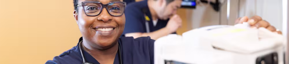 Utica nursing student smiling in a sim lab