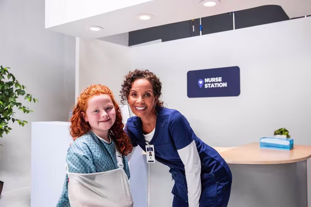 Nurse smiling with child patient