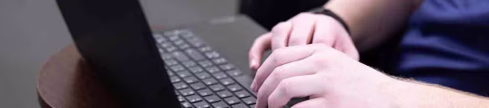 Nursing student typing on laptop