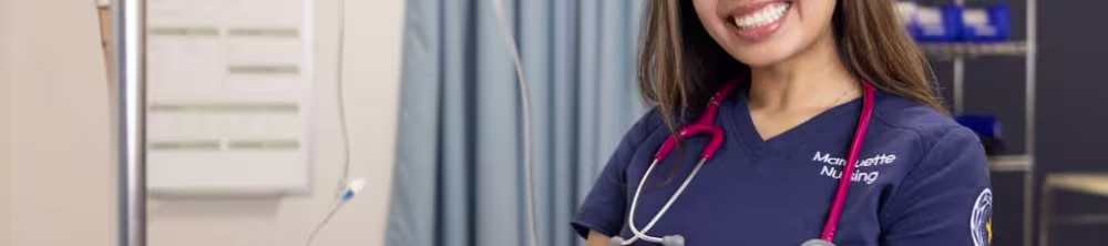 Nursing student smiling in the sim lab
