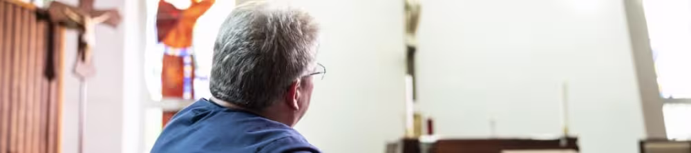 Nurse looking at a cross