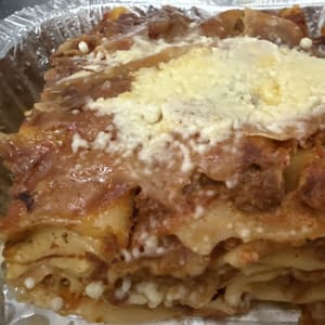 lasagne fresh out of the oven, loaded with rich meat sauce and creamy cheese in every sing