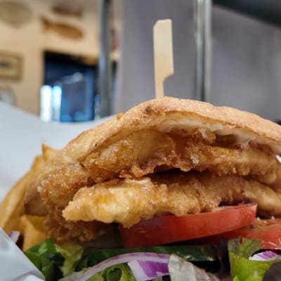 Fresh, local, and filleted in-house. Our Whiting Burger & Chips is ready to satisfy your s