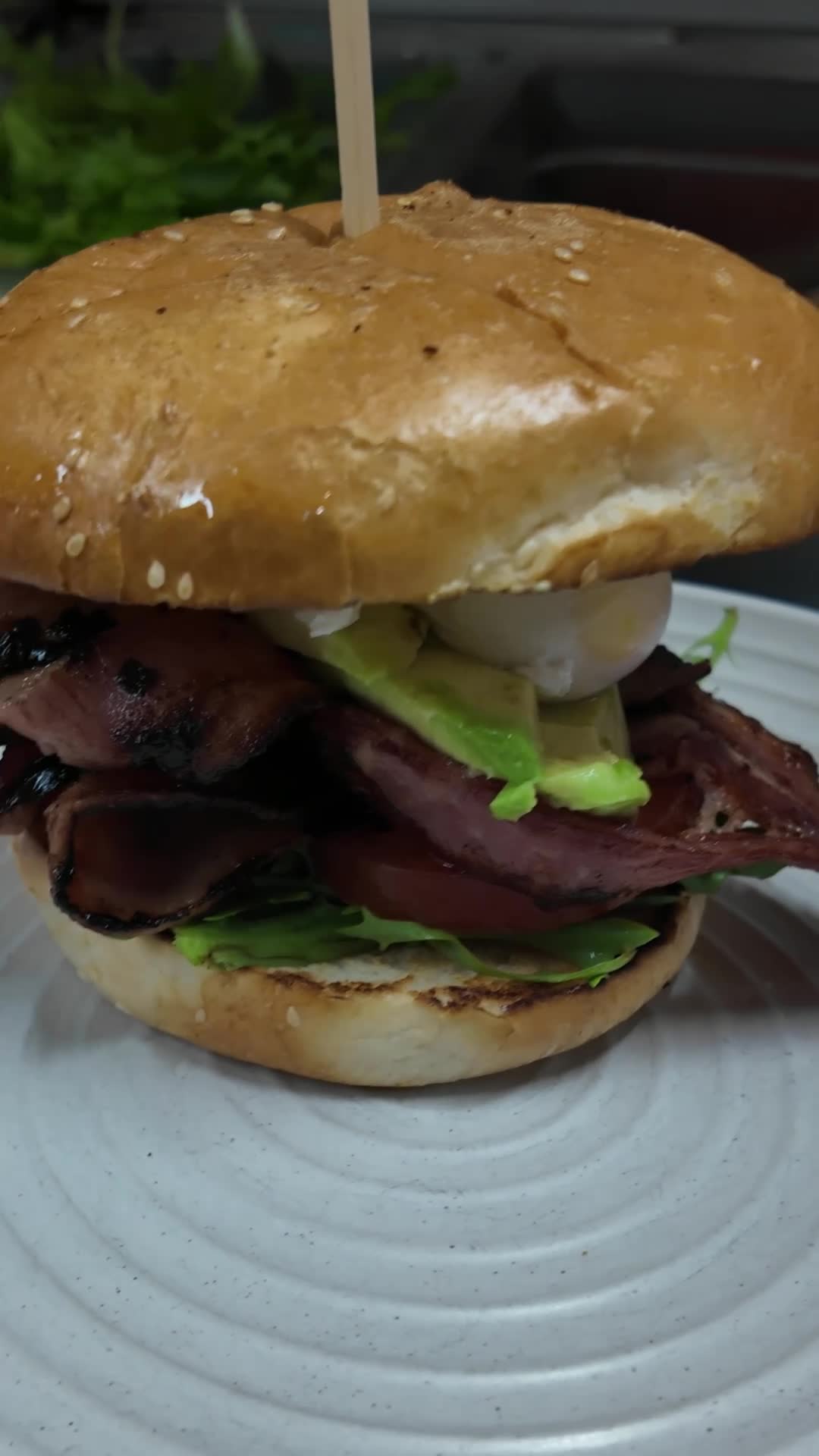 Extra bacon. Poached egg. Avocado. Aioli. Toasted bun. Breakfast that needs both hands. 🥓