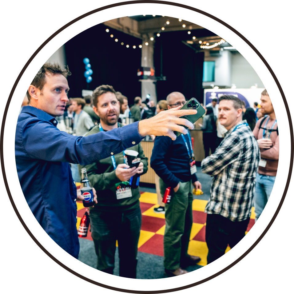 A delegate pointing out something interesting to 3 colleagues.