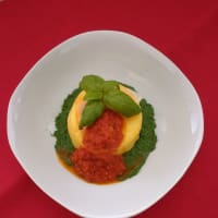 Polenta pie with vegetarian sauce on spinach cream