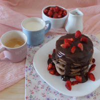 Pancakes with chocolate sauce and strawberries