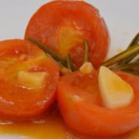 Cherry tomatoes with garlic and rosemary cooked in pan