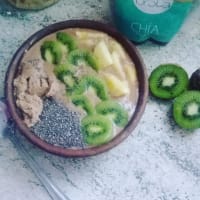 Smoothie bowl of cocoa, seeds and fruits