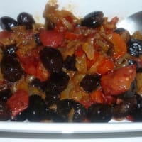Side dish of black onions and tomatoes