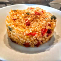 Bulgur with leeks, cherry tomatoes, soy sprouts and capers