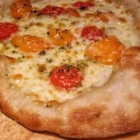 Pizza with yellow and red tomatoes