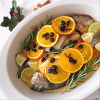 Baked sea bream with orange, lime and cranberry