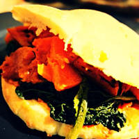 Pita bread stuffed with pumpkin and leaves of black cabbage