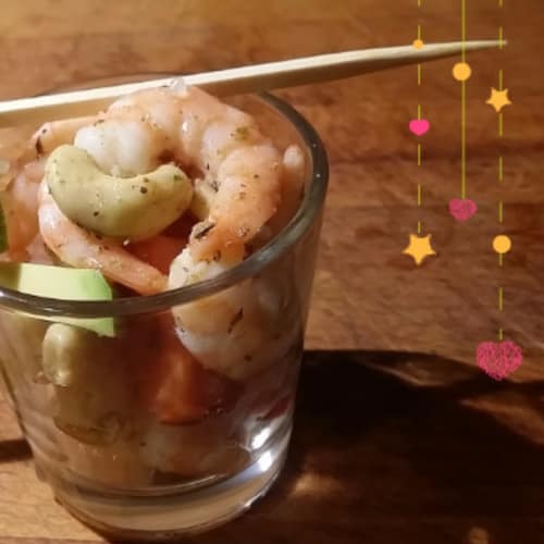 Shot of cashew shrimp with avocado and cherry tomatoes