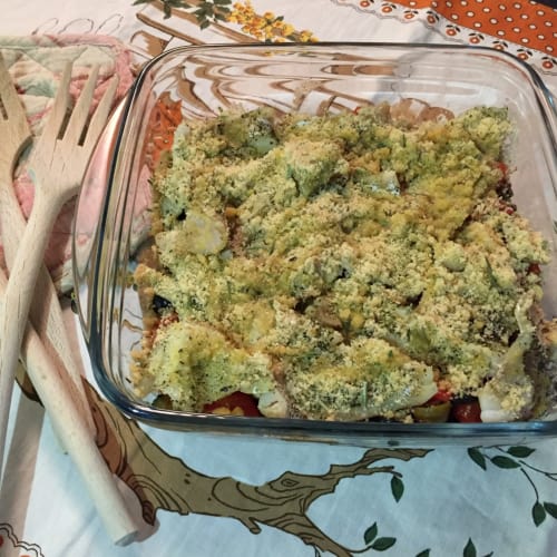 Forms of baked cod with cherry tomatoes and courgettes