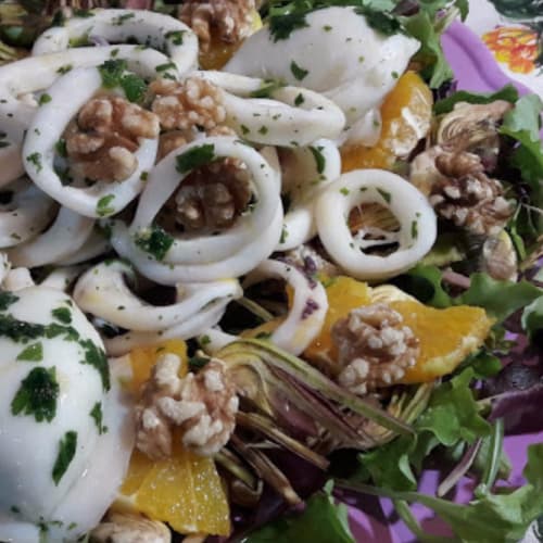 of orange Seafood salad with artichokes and walnuts