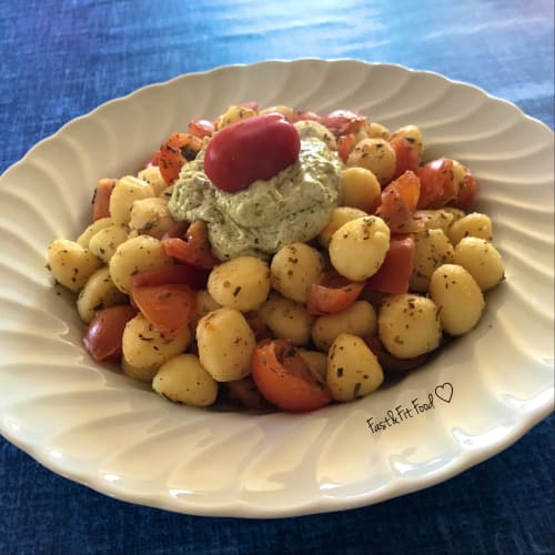 Savory dumplings with cherry tomatoes and quark cream with pesto