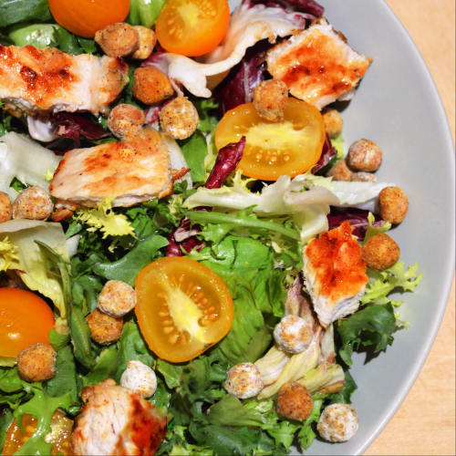 Salad with turkey on plate, cherry tomatoes and crispy chickpeas