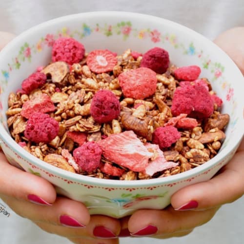 Cocoa granola with strawberries and raspberries