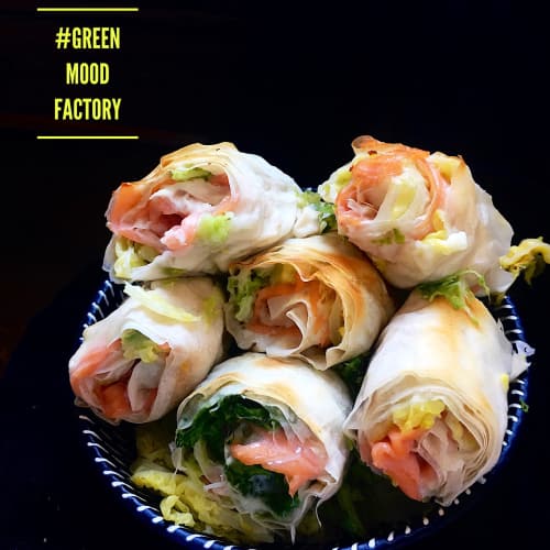 Rolls of phyllo dough, salmon, Greek philadelphia and savoy cabbage