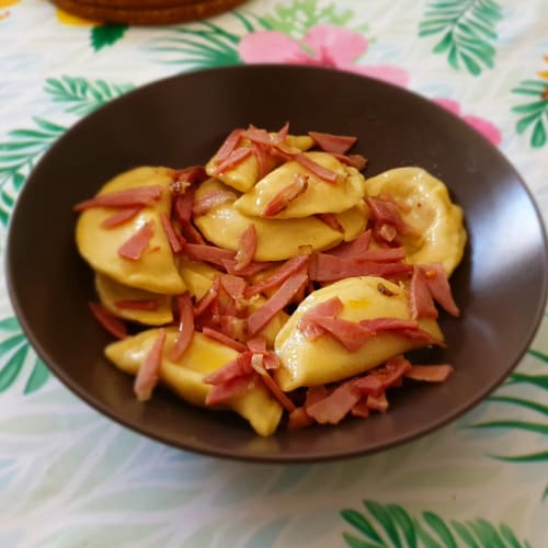 Half-moon filled with truffle-flavored robiola and pumpkin sautéed with speck