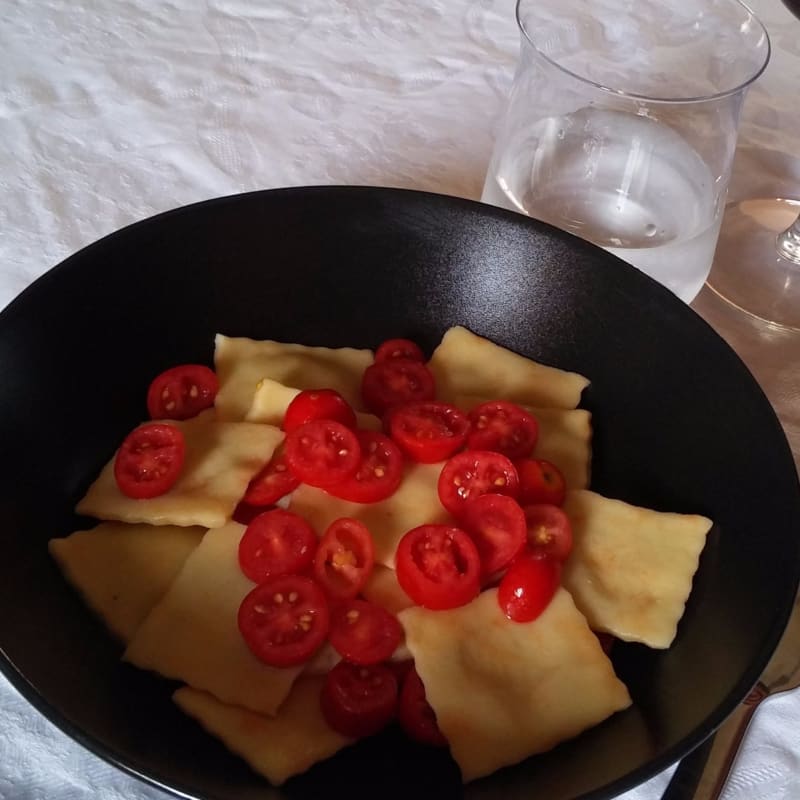 Vegetarian ravioli with ricotta cheese and olives with tomatoes without glut