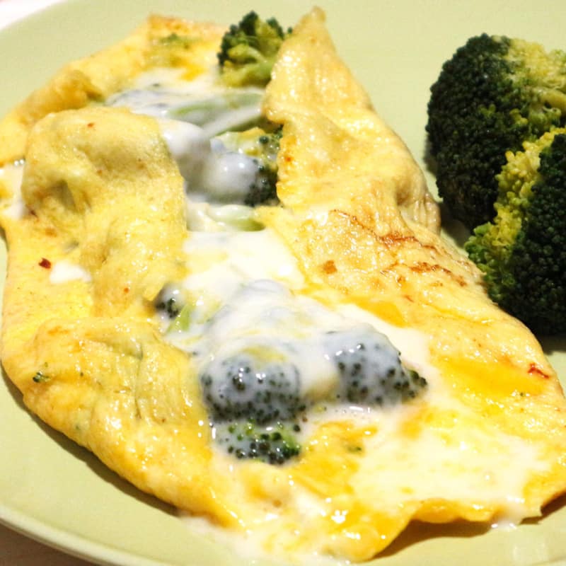 Omelet with cheese slices and broccoli