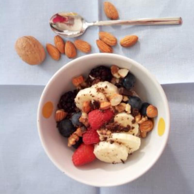 Overnight porridge with berries, almonds, nuts and chocolate