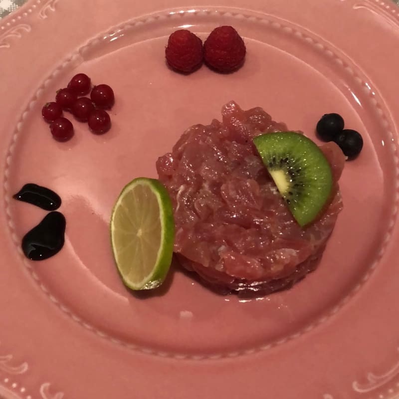 Tuna tartare garnished with raspberry currant blueberry kiwi lime