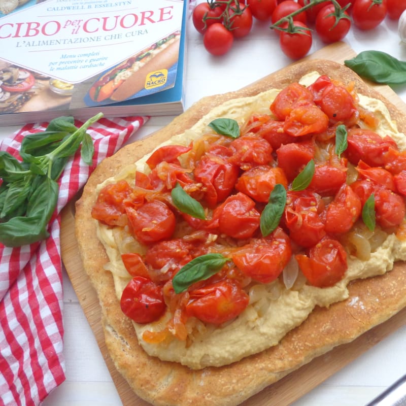 Pizza with hummus, caramelized onions and cherry tomatoes chutney