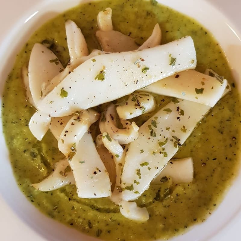 Seared cuttlefish on cream of zucchini and fresh parsley.