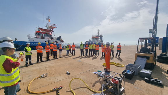 Personnel gather around response equipment during a preparedness activity supporting Repsol's offshore decommissioning operations. Training, planning and operational readiness formed key elements of the project approach.