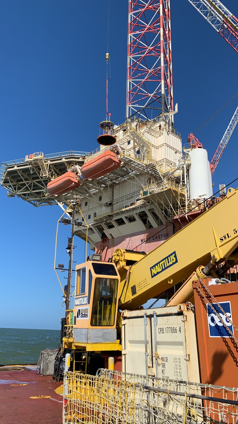  Offshore oil rig in Suriname with safety equipment and support vessels for emergency preparedness.
