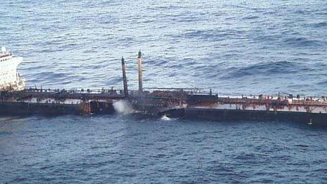 A partially submerged oil tanker with visible structural damage, leaking oil into the ocean. The Prestige oil spill incident in 2002 led to one of Europe’s worst environmental disasters, prompting advancements in oil spill contingency planning and response strategies.