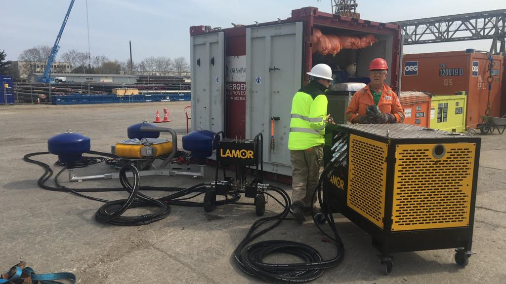 This image depicts the Equipment Hire Services team assembling shoreline response equipment for a training session. The setup features portable containment units like Fastank, designed for quick deployment in coastal areas.