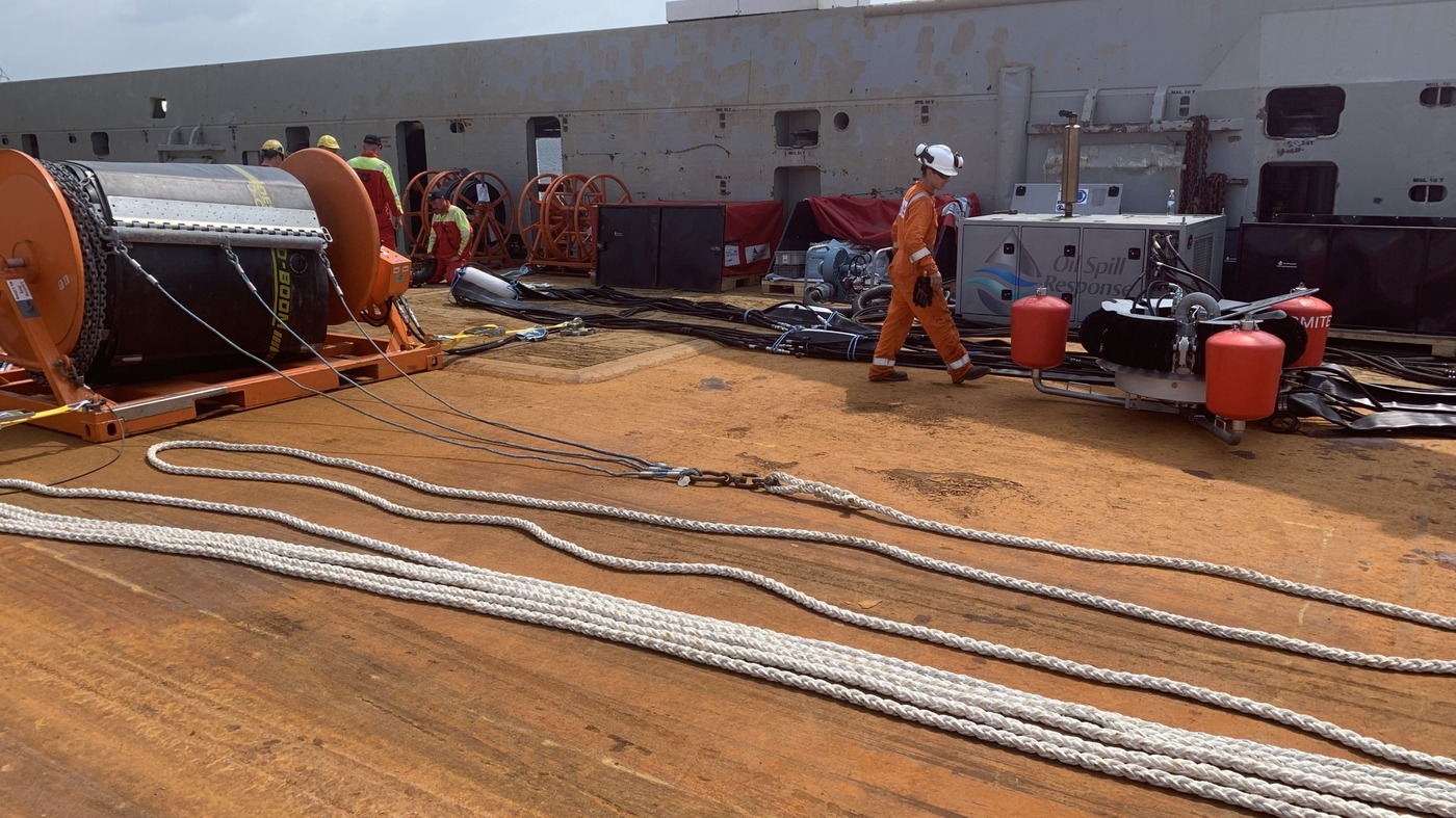 This image depicts the deployment of containment booms as part of equipment hire services supporting decommissioning activities. Such operations ensure effective spill containment and environmental protection during offshore infrastructure decommissioning.