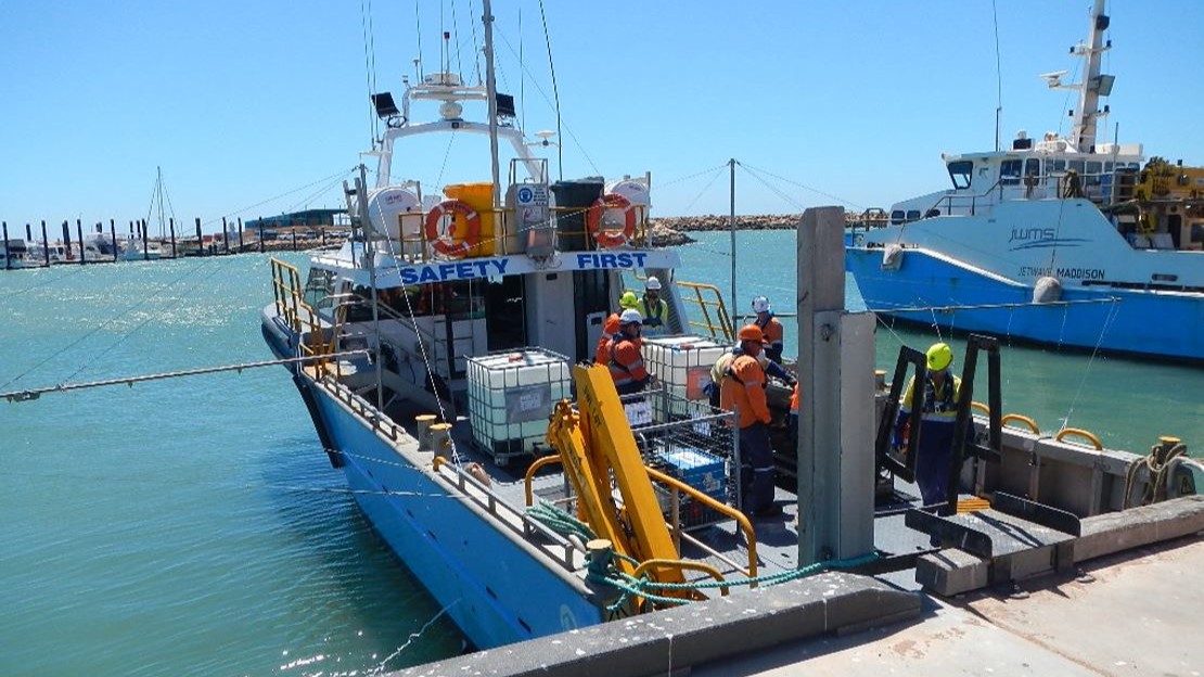  A dedicated oil spill response vessel docked, with trained personnel preparing containment equipment and dispersant tanks for rapid deployment as part of the Western Australia MEER exercise.
