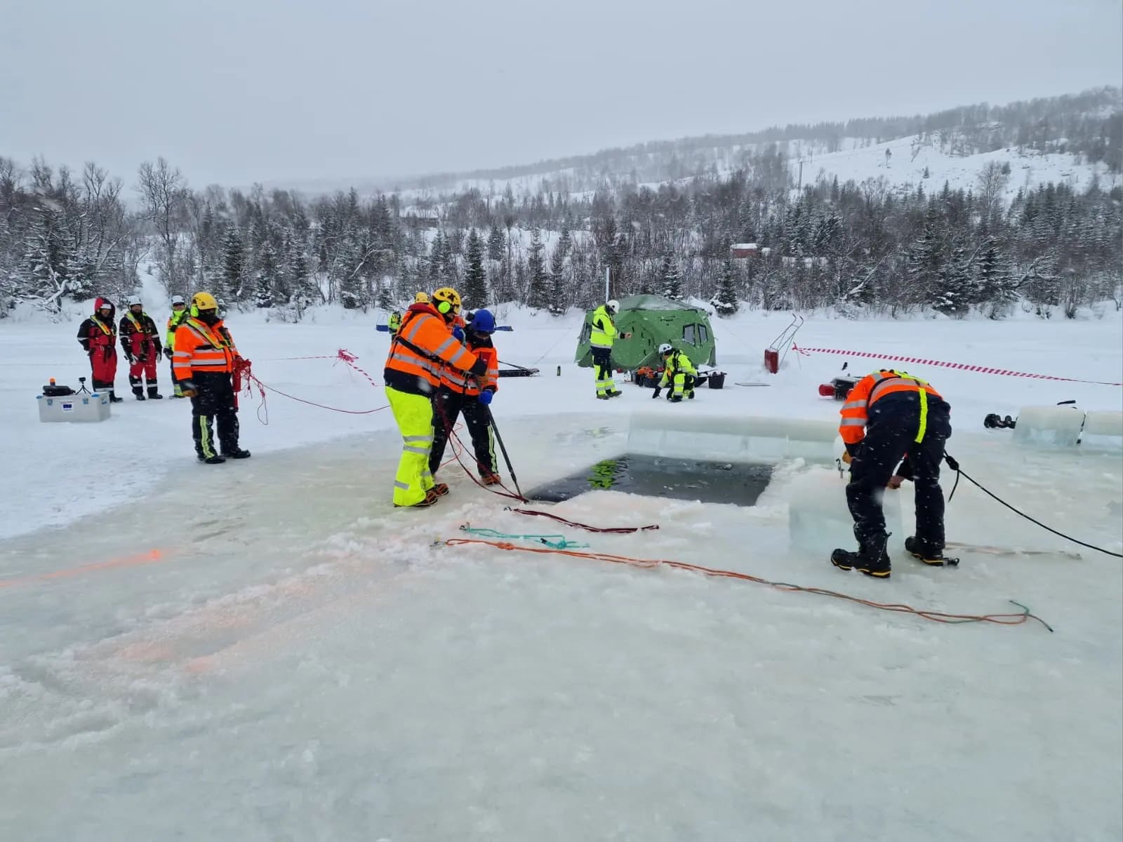 Personnel conducting field-based training on frozen terrain. Exercises like these help responders understand operational challenges associated with cold temperatures, ice cover and limited access to remote locations. exercises allow teams to test equipment, procedures and decision-making in realistic Arctic conditions.