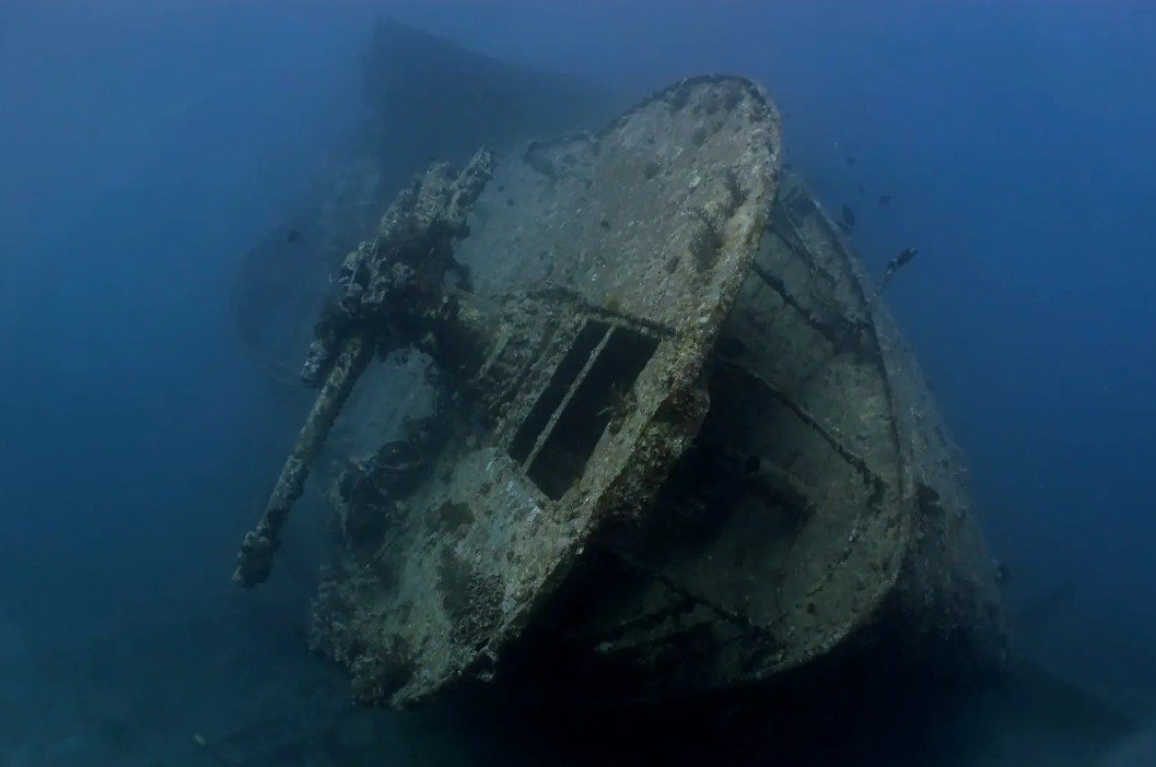 Underwater image showing structural deterioration of a historic shipwreck.