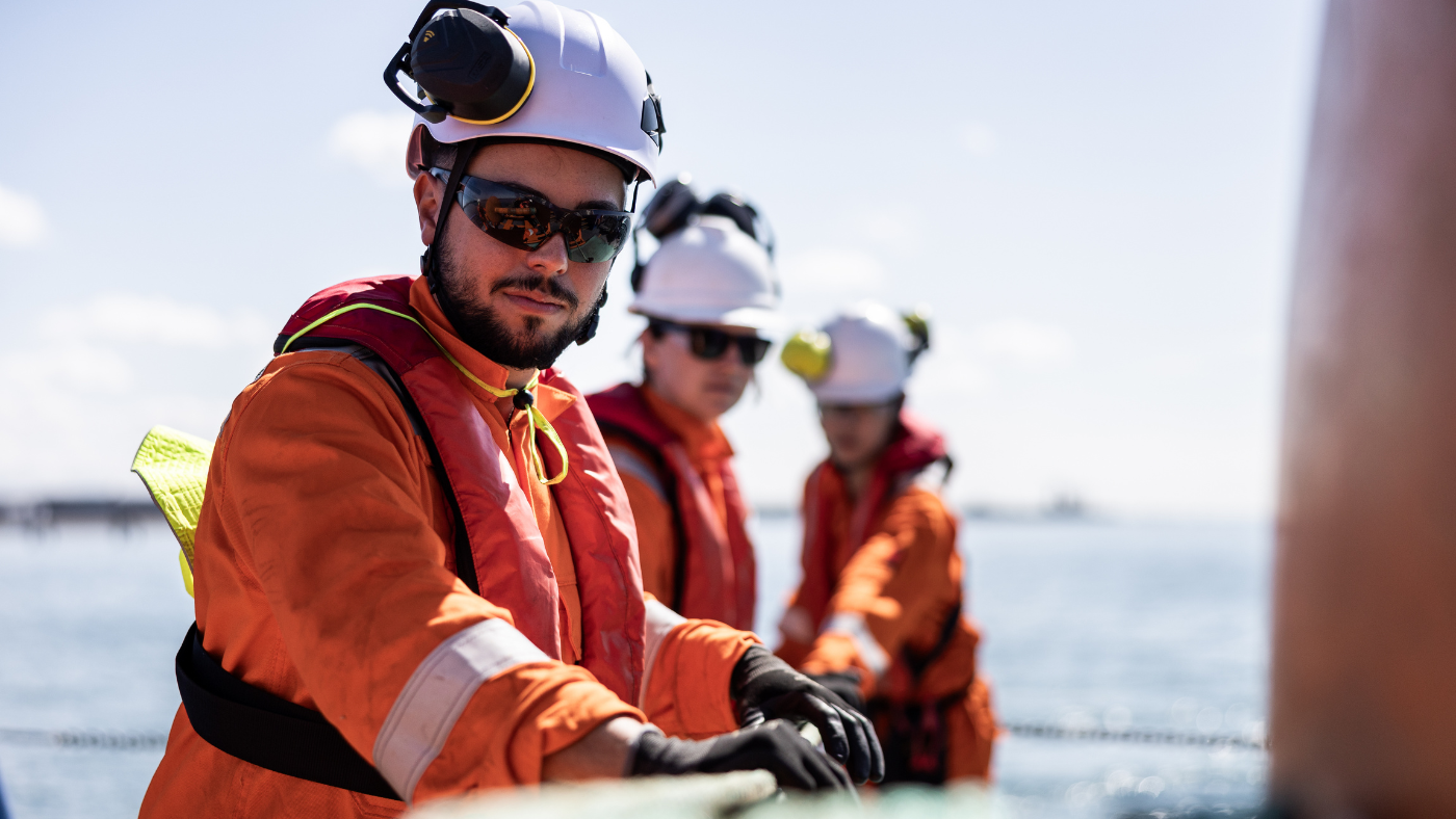 Responders applying specialist oil spill response skills during training in a nearshore environment