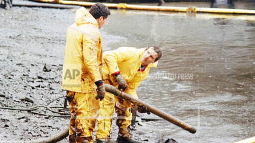 Exxon Valdez - responders trial a vacuum system for oil spilled on Block Island, Alaska in 1989.